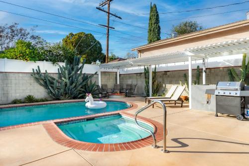a swimming pool with a rubber duck in a backyard at Modern Oasis with Pool & Jacuzzi near Universal Studios in Los Angeles