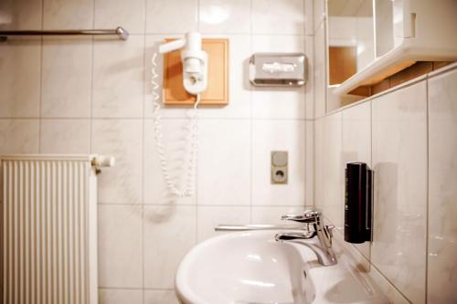 a bathroom with a sink and a phone on the wall at Smart Resorts B&B 2 BB2 324 in Winterberg