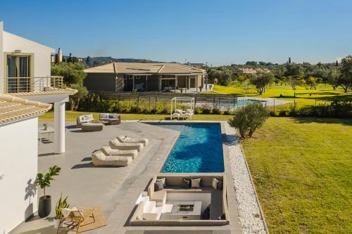 a villa with a swimming pool and a house at Villa Felicity in Svoronata
