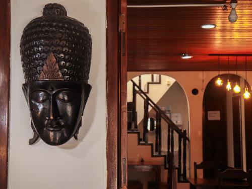 a mask hanging on a wall next to a staircase at Pousada Pura vida in Itacaré