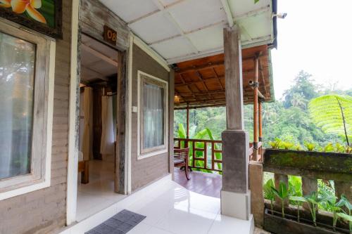 an open door of a house with a balcony at Doni House & Villas in Ubud