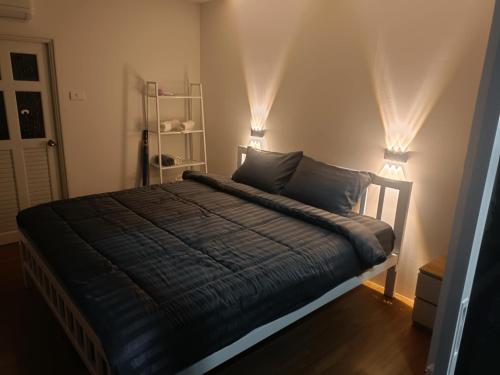 a bedroom with a bed with two lights on it at The Bay Koh Mook in Trang