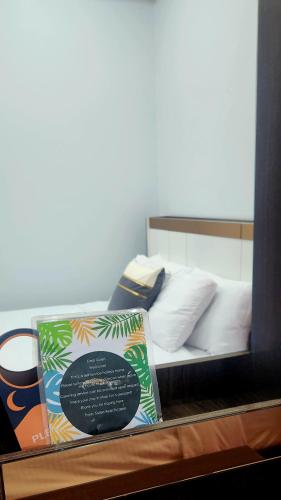 a display of a bed with a book on it at Sisters Real Escapes - Entire Villa in Mae Sot