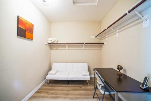 a living room with a white couch and a table at Charming Pet-Friendly Getaway in Sunny Beaumont home in Beaumont