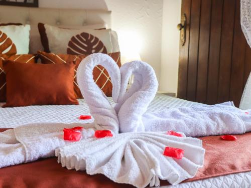 two swans towels sitting on top of a bed at Pousada Pura vida in Itacaré