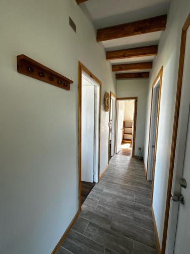 a hallway with white walls and tile floors at Casa Olas, Refugio Costero in Curanipe