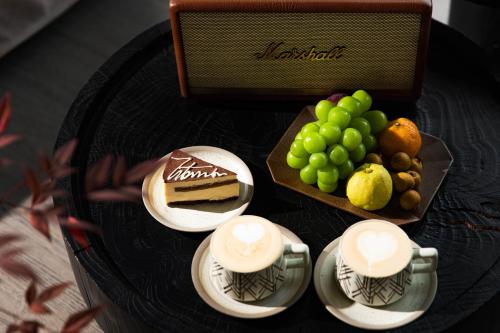 a table with a cake and a plate of fruit at 丽思漫 心宿穹庐四野供氧庄园 in Shangri-La