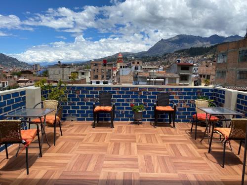 a patio with chairs and tables on a roof at El Jacal Classic in Huaraz