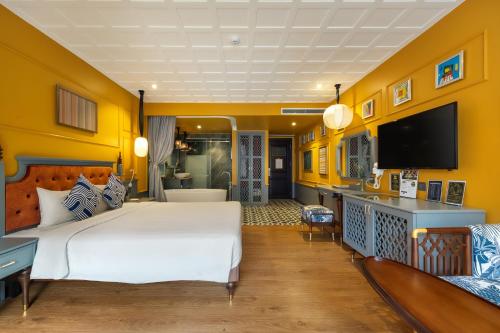 a hotel room with a bed and a flat screen tv at Son Hoi An Boutique Hotel & Spa in Hoi An