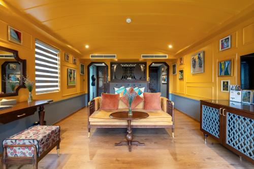 a yellow living room with a couch and a table at Son Hoi An Boutique Hotel & Spa in Hoi An