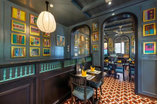 a restaurant with blue walls and a table and chairs at Son Hoi An Boutique Hotel & Spa in Hoi An