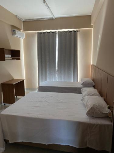 a bedroom with two beds and a window at Hotel Primavera Palace in Salinas