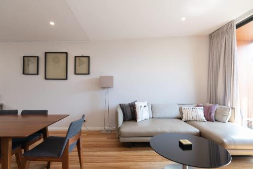 a living room with a couch and a table at Modern Home in Erskineville w AC and Parking in Sydney