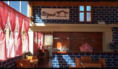 a restaurant with tables and chairs and a brick wall at El Jacal Classic in Huaraz