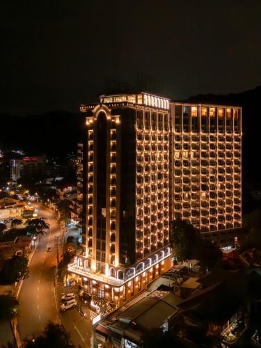 a large building with lights on it at night at OYSTER BAY HOTEL VUNG TAU in Vung Tau