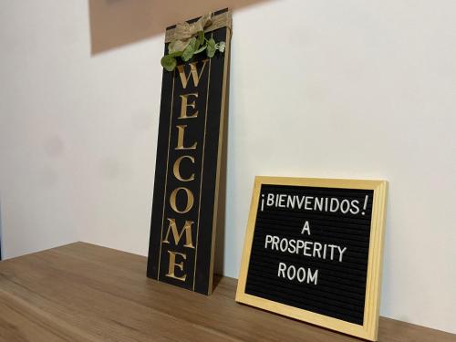 a sign sitting on top of a table with a sign at Prosperity Room - a solo una cuadra del parque in Carmen de Viboral