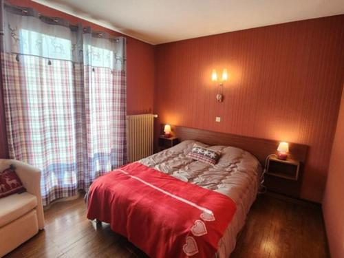 a bedroom with a bed with red walls and a chair at Grand appartement entre pistes à La Chapelle d'Abondance avec balcon et parking - FR-1-692-108 in Abondance