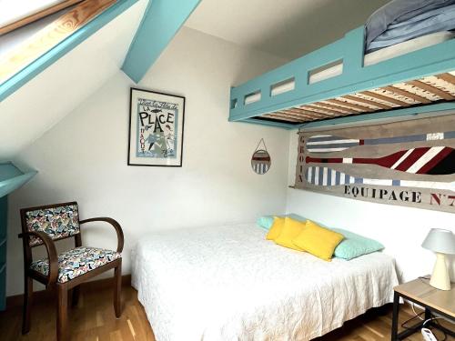 a bedroom with a bed and a bunk bed at Maison familiale proche plage Groix, jardin et garage - FR-1-813-6 in Groix