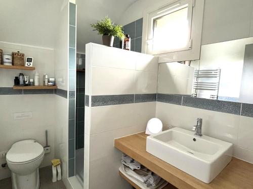 a bathroom with a sink and a toilet at Maison familiale proche plage Groix, jardin et garage - FR-1-813-6 in Groix