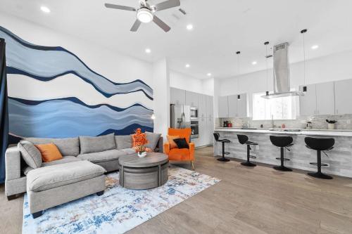 a living room with a couch and a kitchen at Spacious Houston 3Bed3 Bath Family Townhome in Houston