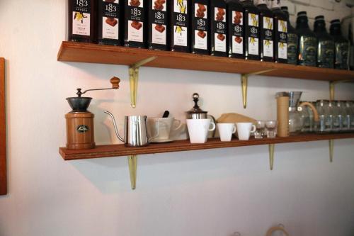 a shelf with cups and bottles on a wall at Pyeongtaek 1981 in Pyeongtaek