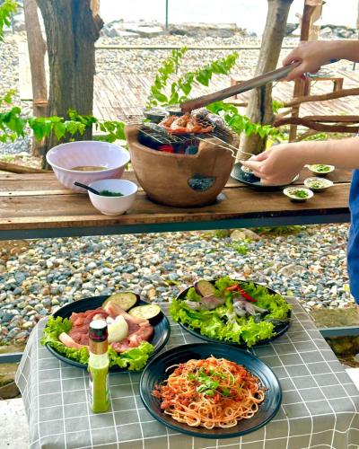 a table with two plates of food on it at Bãi dài Camping in Nha Trang
