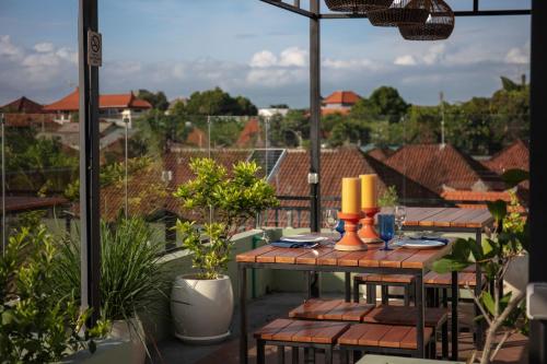 a patio with a table and chairs on a balcony at Verdant Bali Tirta Lepang in Ketewel