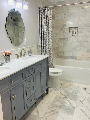 a bathroom with a sink and a toilet and a tub at Travelers Rest Treasure - Sleeps 8 - 3 Bedroom 2 Bath - Pets Welcome in Travelers Rest