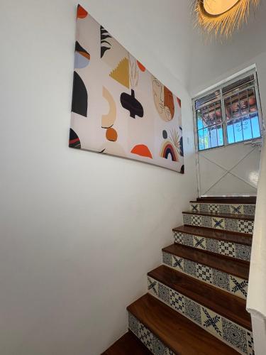 a painting on the wall above a set of stairs at Private Room in a Boho House N1 in Puerto Vallarta