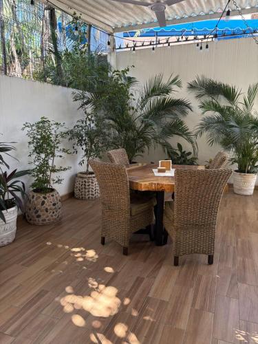 a table and chairs in a room with plants at Private Room in a Boho House N1 in Puerto Vallarta