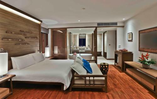 a bedroom with a large bed and a television at Pimalai Resort & Spa in Ko Lanta