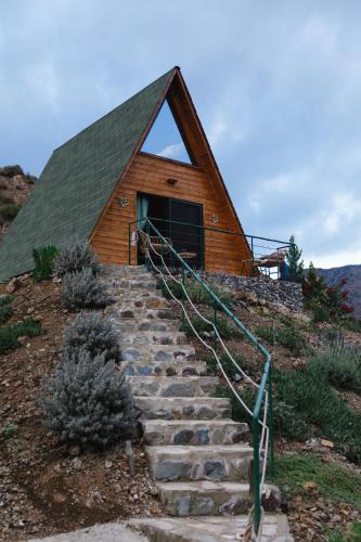 a house with stairs leading up to a building at Cozy Glamping Cabin With Pool, Perfect For Couples & Families in Arakapas