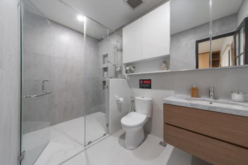 a bathroom with a toilet and a shower and a sink at Verdant Bali Tirta Lepang in Ketewel