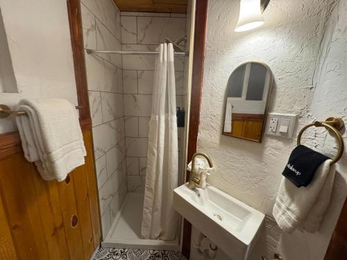 a white bathroom with a sink and a shower at Three Pines Cabins in Big Bear Lake