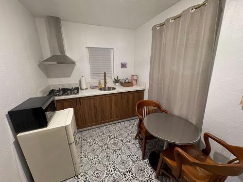 a kitchen with a small table and a kitchen with a sink at Three Pines Cabins in Big Bear Lake