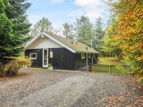 a small house with a fence in front of it at 6 person holiday home in Ansager-By Traum in Ansager