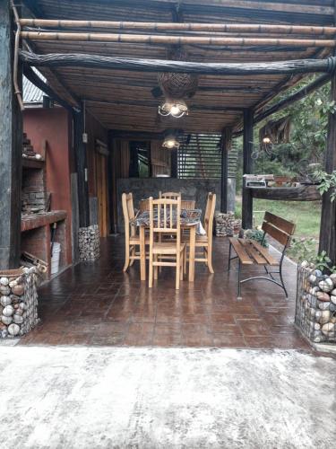 a patio with a table and chairs on a patio at La Rustica in El Durazno