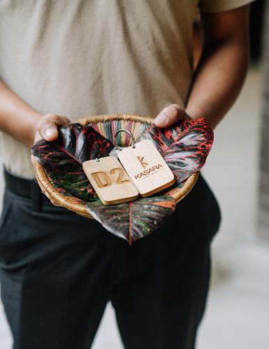 a person holding a basket with a plate of food at Kasara Chitwan in Chitwan