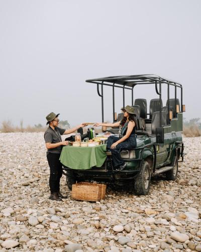 a group of people sitting at a table in a vehicle at Kasara Chitwan in Chitwan