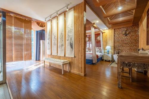 a living room with a bench and a bed in it at Nanxun Luohua Old House Inn in Huzhou