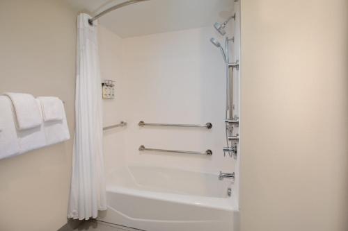 a bathroom with a shower and a white tub at Holiday Inn Express & Suites I-26 & Us 29 At Westgate Mall by IHG in Spartanburg