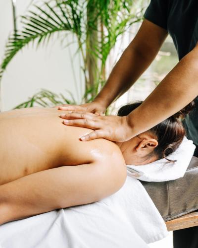 a woman getting a massage from a therapist at Kasara Chitwan in Chitwan