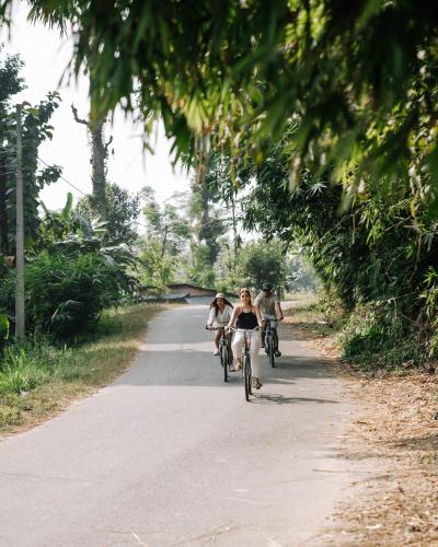 a group of people riding bikes down a road at Kasara Chitwan in Chitwan