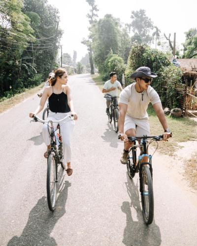 a group of people riding bikes down a road at Kasara Chitwan in Chitwan