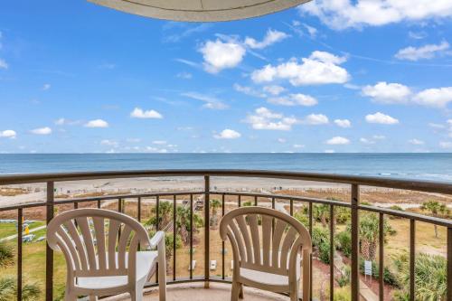 two chairs on a balcony overlooking the beach at Oceanfront Condo at Meridian Plaza in Myrtle Beach