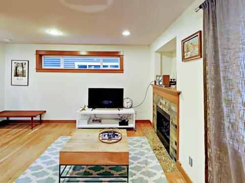 a living room with a tv and a fireplace at Fremont & Woodland Park Zoo Cozy Living in Seattle