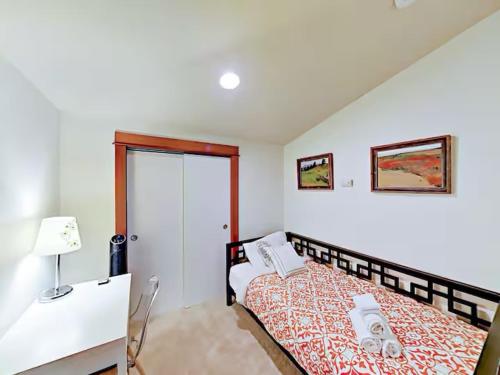 a bedroom with a bed and a desk with a lamp at Fremont & Woodland Park Zoo Cozy Living in Seattle