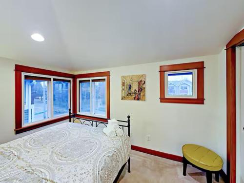 a bedroom with a large bed and two windows at Fremont & Woodland Park Zoo Cozy Living in Seattle