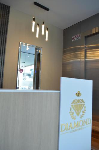 a sign in front of a dermatologist office with a mirror at Hotel Diamond Luxury Tunja in Tunja
