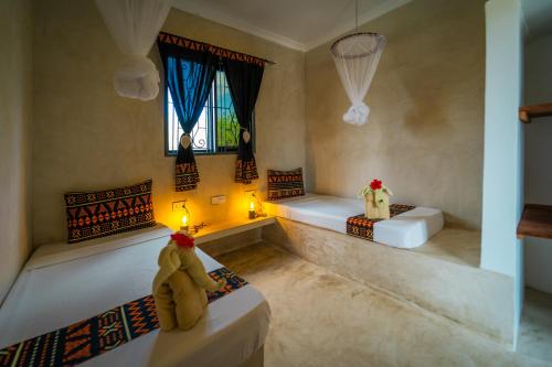 Postel nebo postele na pokoji v ubytování Blooming Zanzibar